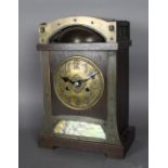 An early 20th Century oak and brass mantel clock of Arts & Crafts design possibly retailed by