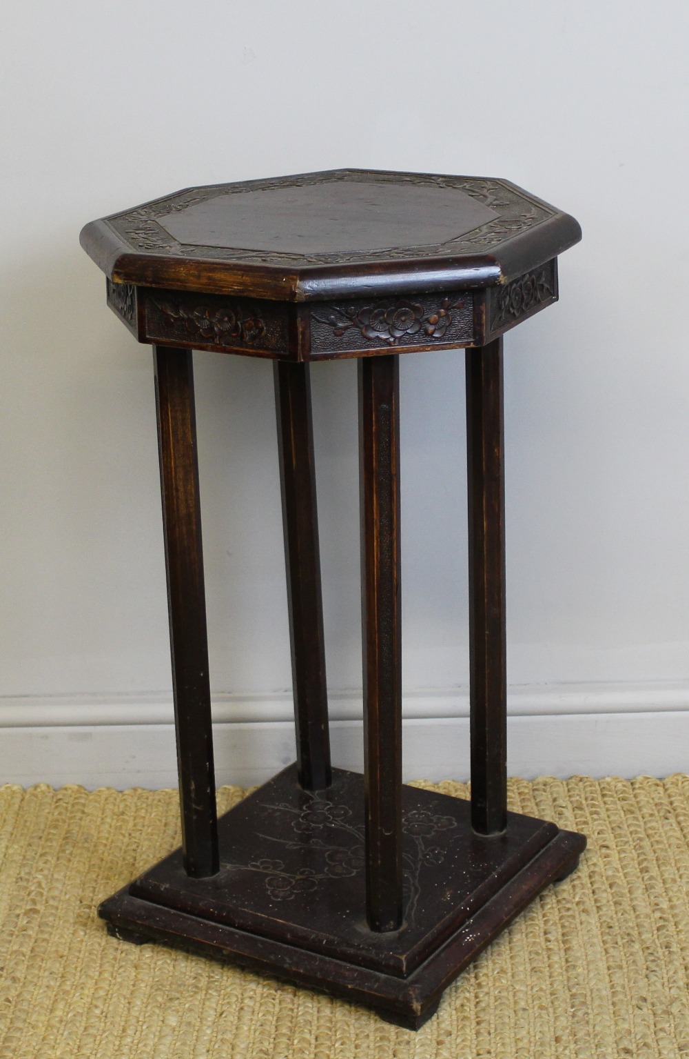 A 19th Century Chinese stained wood octagonal stand, carved with prunus blossom, 45cm wide x 75cm