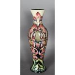 A modern Moorcroft tube lined pottery slender baluster shaped vase - Trial piece with flowers in