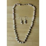 A freshwater pearl, emerald and 925 silver necklace & searring suite 46cm & 2cm Good condition.