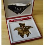 A Georg Jensen 'Christmas 2001' gold plated ornament, boxed. Good used condition.