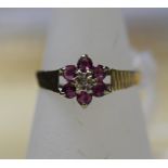 A 9ct gold ruby and diamond cluster ring, ring size O