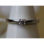 An 18ct white gold solitaire diamond ring, the diamond approx 0.05ct, ring size L, gross weight