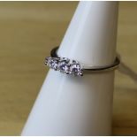 An 18ct white gold three stone diamond ring, the diamonds approx 0.15ct, ring size L, gross weight