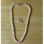 A freshwater pearl & 925 silver necklace and earring suite 46cm & 1.5cm. Good condition.