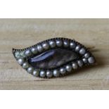 A Victorian seed pearl and gilt metal mourning brooch (two pearls missing)