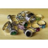 A group of fifteen silver dress rings (two silver gilt) set with variety of clear and coloured