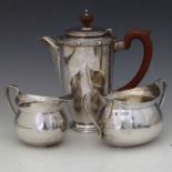 Hammered silver oval milk jug and sugar basin, Haseler Bros, London 1912; a silver coffee pot with