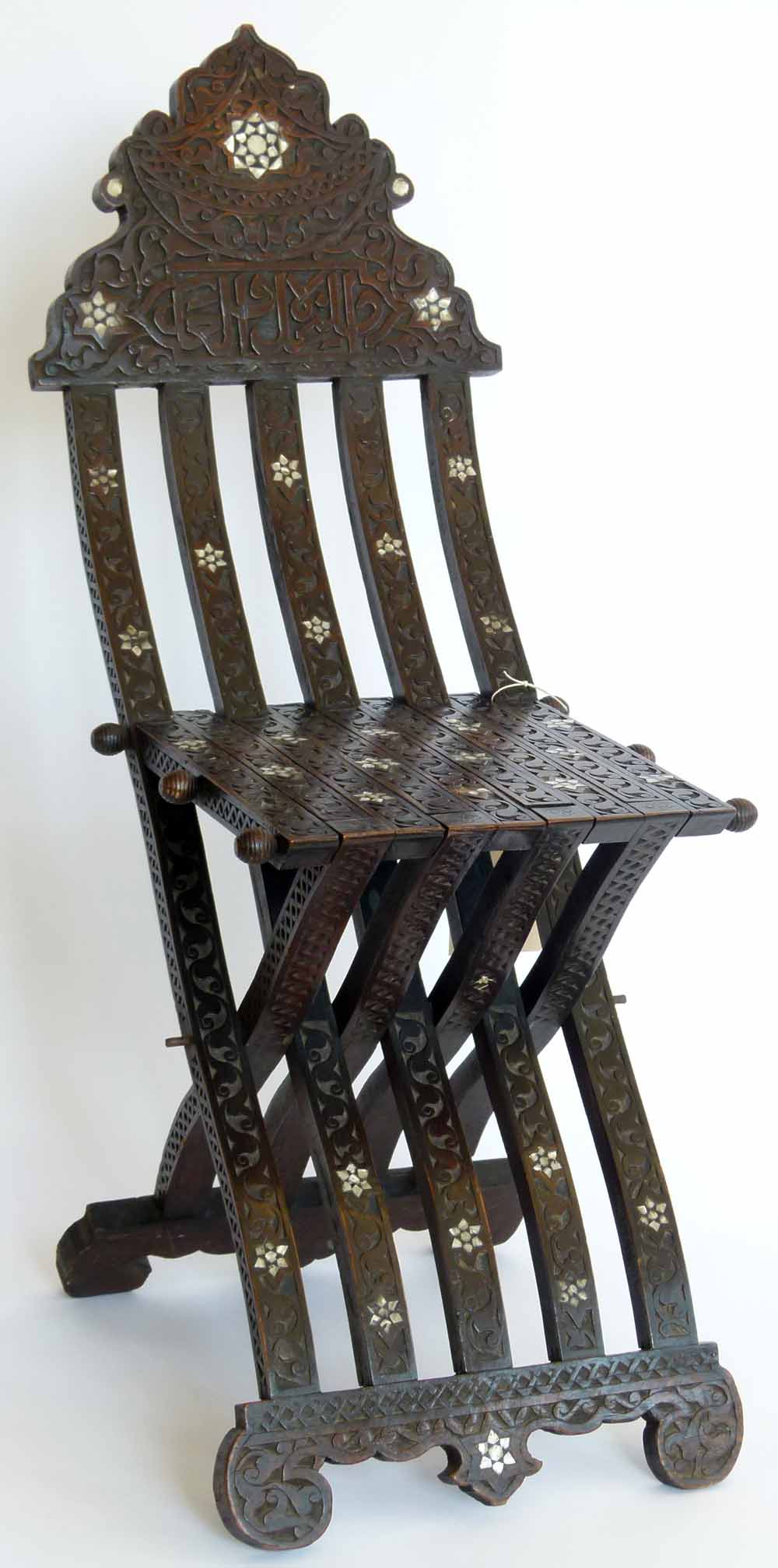 Islamic hardwood folding chair with mother-of-pearl inlay, Arabic calligraphy, circa 1900. Condition