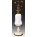 White glass and brass table lamp fitted for electricity, circa 1900, the bell shaped body on a