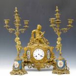 French gilt brass mantel clock, the ornate floral case set with Sevres style panels and surmounted