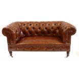 Victorian Chesterfield sofa by Howard, covered in brown leather, deep button upholstering with