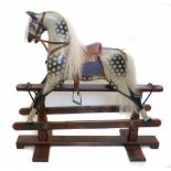 Early 20th century rocking horse, painted dapple grey fitted with glass eyes, wearing leather tack