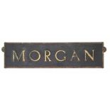 Morgan Motor Co. showroom advertising sign, brass frame containing rectangular black plastic