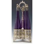 Victorian trefoil electro-plated decanter stand holding three amethyst glass bottles with grape