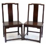 Pair of 20th century Chinese hardwood chairs, with single splat back and solid seats.