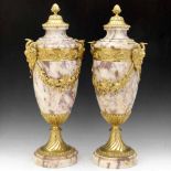 Pair of neo-classical pink marble cassolets with gilt metal mounts, height 51cm.