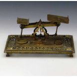 Victorian cast brass set of domestic postage scales, the ornate rectangular base set with three