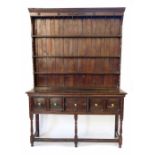 18th century Jacobean design dresser, the three shelf rack standing on two plank rectangular top,