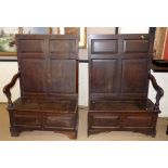 George III oak settle with four large and four small panels to back and two lift-up sections to base