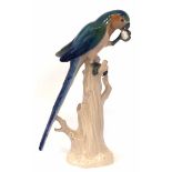 Meissen Parrot, modelled perched on a tree stump, early 20th century, impressed, incised 20X and