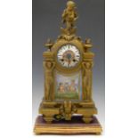 French gilt spelter mantel clock with porcelain panels the case surmounted by a cherub riding a