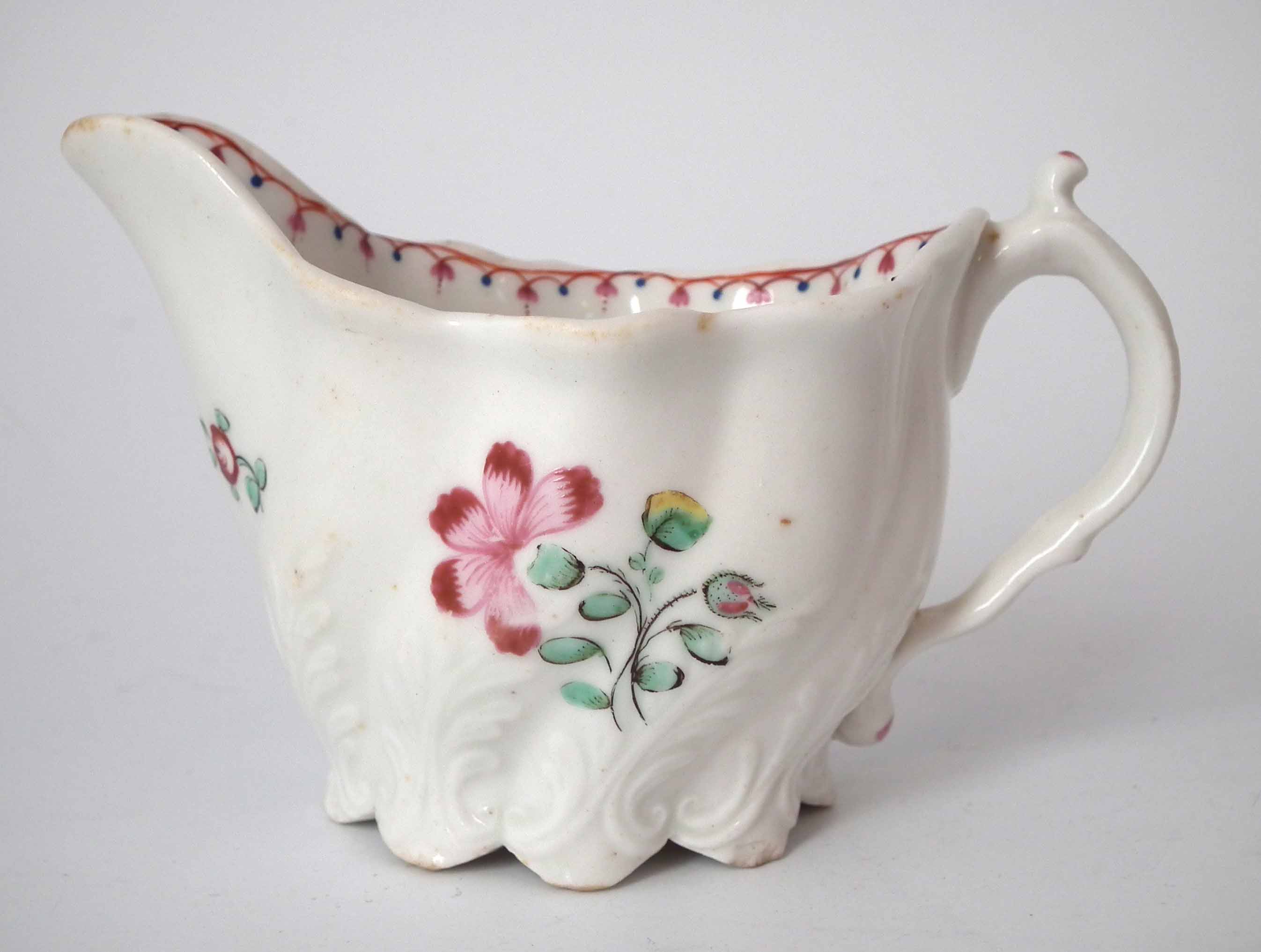 Caughley Low Chelsea Ewer circa 1790, painted with flora and moulded with acanthus leaves, 11cm wide