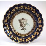 Worcester plate circa 1780, painted with a classical urn within gilt and navy blue border,