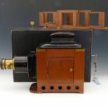 Triumph magic lantern in mahogany, brass and steel plate, fitted for electricity, with two
