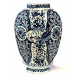 Large Delft vase, with ribbed octagonal body, painted with blue flora and figures in boats,