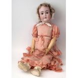 Large bisque head doll attributed to Kestner, with pink lacework dress and lace bonnet, no marks