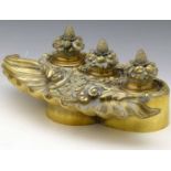 Victorian cast brass ink stand, of rococo style, the shell-shaped pen tray backed by two wells and a