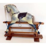 Rocking horse, painted dapple grey on pine base, 118cm overall height, 135cm overall width.