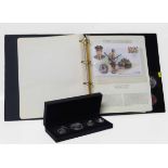 The 2012 UK Britania silver proof set, also a history of World War II folder with two medals, D-