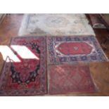 Chinese fringed rug and three Persian carpets. Condition report: see terms and conditions