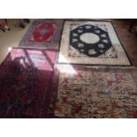 Chinese fringed rug and three Persian carpets. Condition report: see terms and conditions