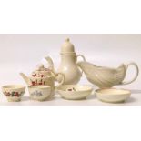 Two miniature cream ware tea bowls and saucers, a teapot, miniature coffee pot and cream boat.