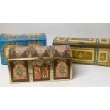 Three German vintage dome top cake storage tins, each with brightly coloured transfer decoration,