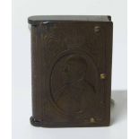 An Edward VII bakelite commemorative vesta case in the form of a book, the front with a portrait