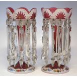 Pair of Victorian glass lustres, with ruby bodies overlaid in white, cut through, enamelled and