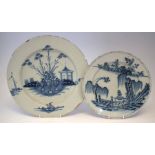 Two Delft chargers circa 1770, painted in blue with landscapes, the largest charger measures 37cm