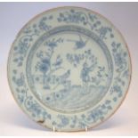 Delft charger circa 1740, painted in blue with a figure within a garden, 36cm diameter Condition