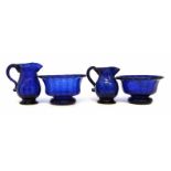 Two blue glass jugs and bowls, with moulded bodies, 18th / early 19th century, (4) the bowls measure