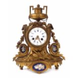 French gilt bronze mantel clock, mounted with porcelain panels, the drum two train movement striking