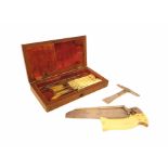 A 19th century mahogany cased field amputation kit, the fitted interior with an ivory handled