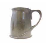 A Tudric pewter mug, model 066, the plain baluster body with loop handle with whiplash terminals,