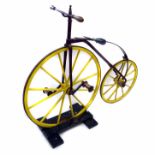 Boneshaker, steel frame with turned wooden handles to steering bar, steel banded wooden wheels,