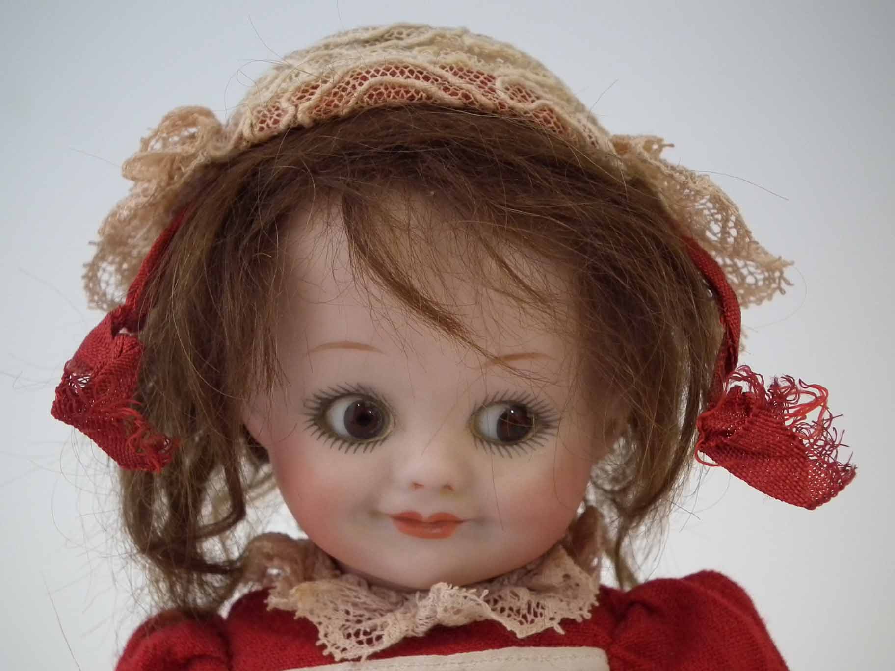 Armand Marseille 'googly eye' doll, mould number 323 4/0, dressed in red costume, with stand, 22cm - Image 2 of 11