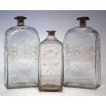 Two glass flask shape decanters, with rectangular bodies engraved with flora, silver hallmarked