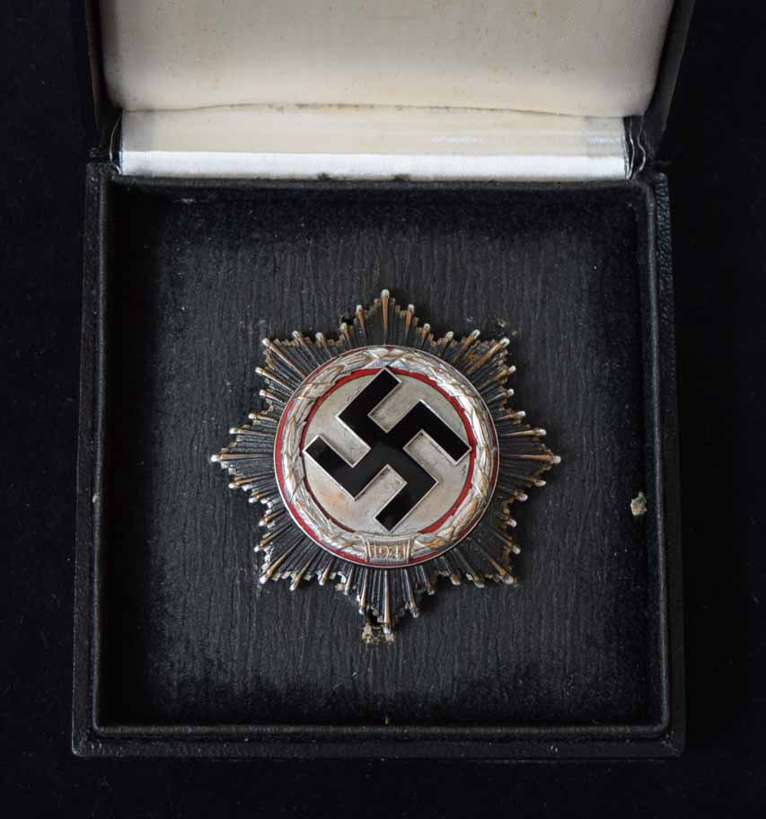 A rare Second World War Nazi German Cross in silver with black enamel Swastika to centre and red